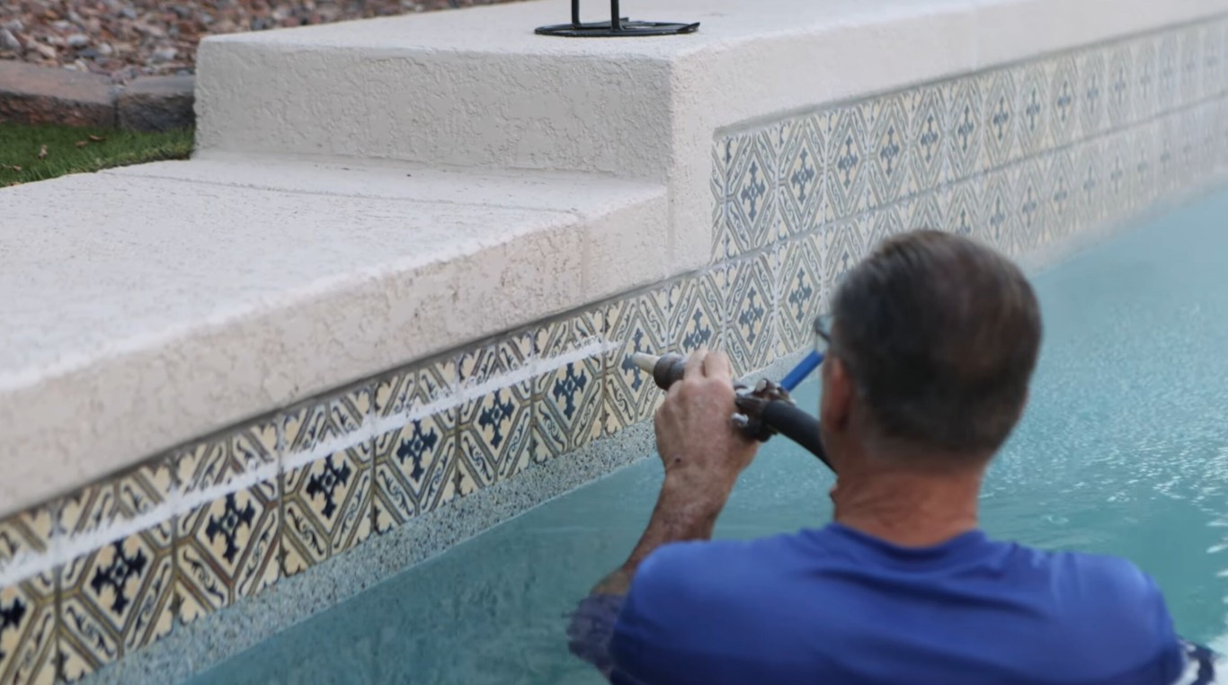 Professional pool technician performing precise tile cleaning and calcium removal in Union City, CA